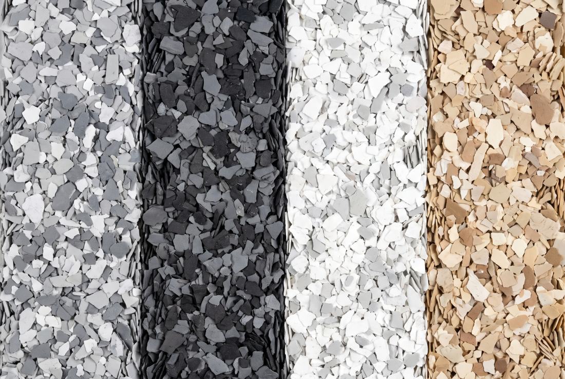 Four garage floor flake blends laid side by side as bands: grey and white, charcoal, white, and a warm neutral