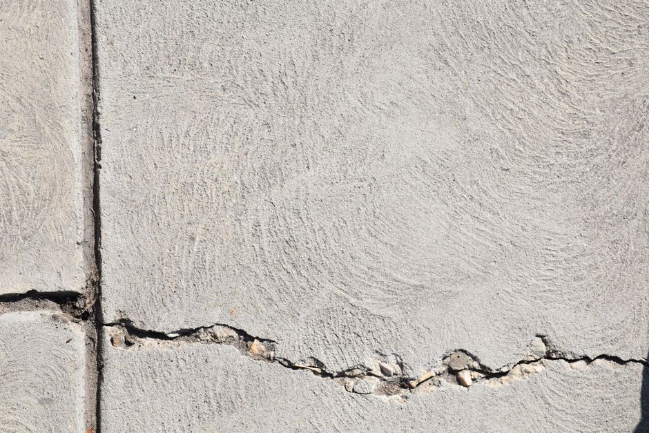 Crack running across a bare concrete garage slab
