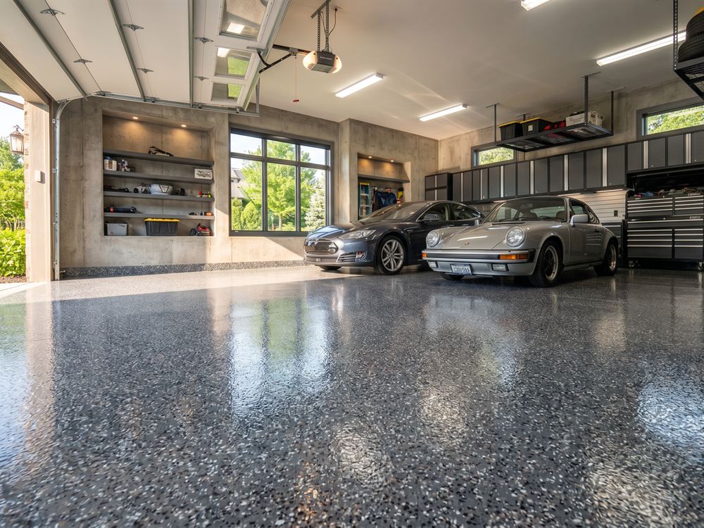 Three-car garage with two sports cars on a high-gloss flake coated floor